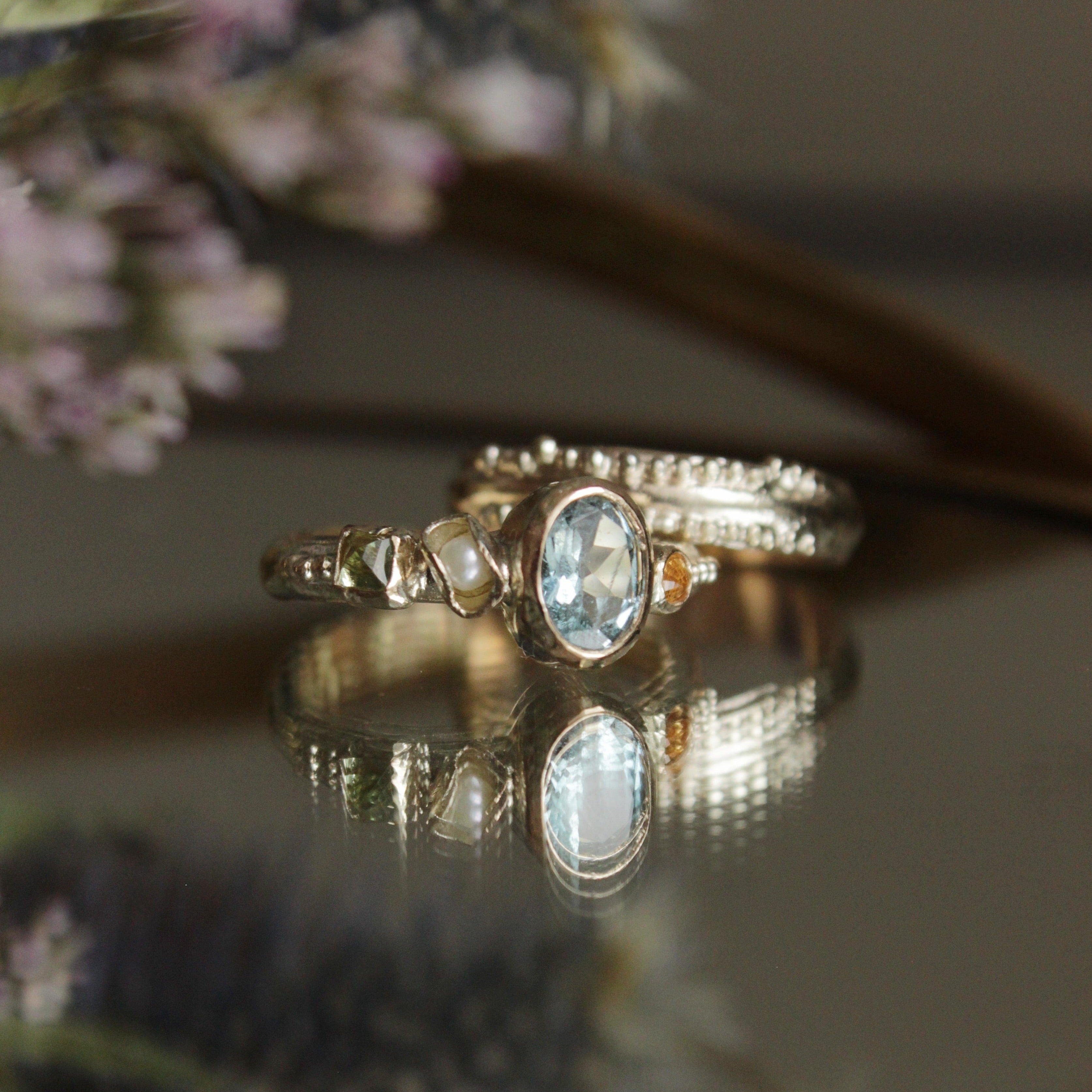 Bespoke, hand crafted 9ct gold alternative engagement ring. The ring features a vibrant oval Aquamarine, a pearl and sapphires. Handcrafted in Frome by Josie Mitchell Jewellery for the alternative bride and ocean lover.