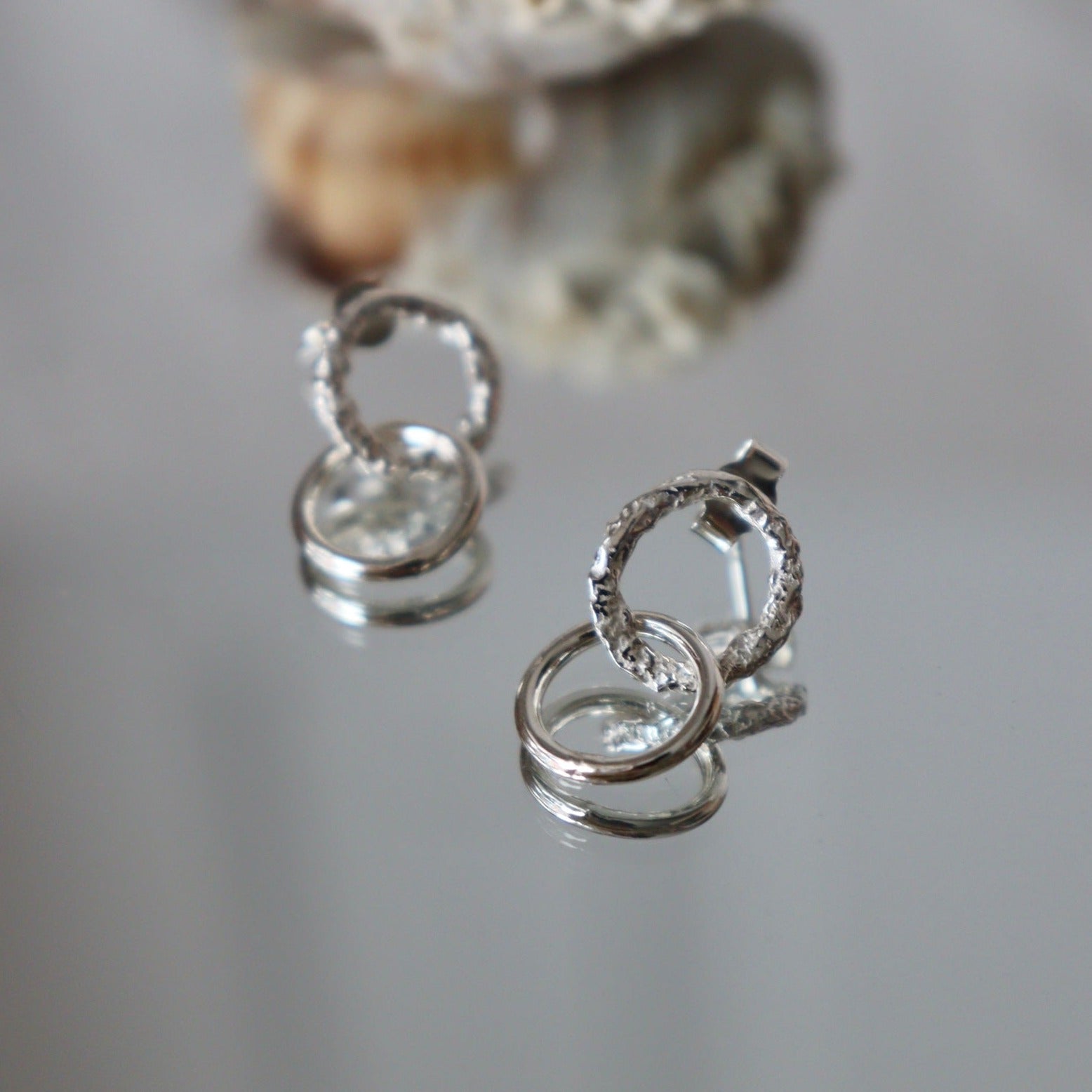  These delicate little studs feature two small hoops that hang just below the ear lobe. The top hoop has a gorgeous reticulated and organic texture and the bottom hoop has a contrasting smooth finish. 