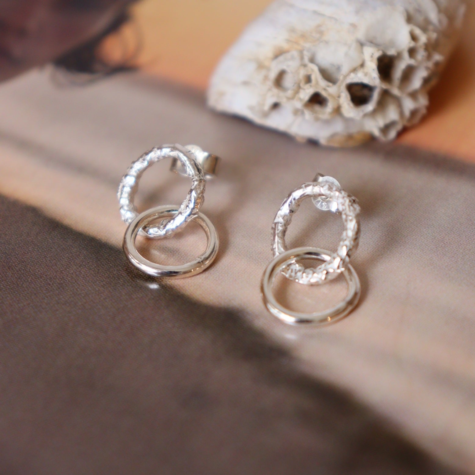  These delicate little studs feature two small hoops that hang just below the ear lobe. The top hoop has a gorgeous reticulated and organic texture and the bottom hoop has a contrasting smooth finish. 