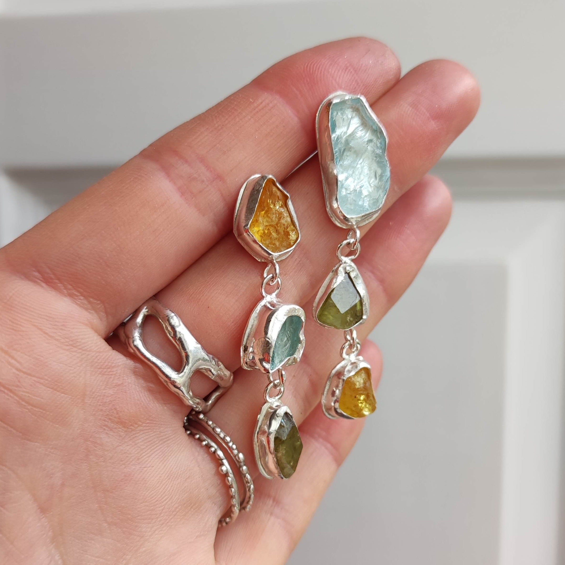 These stunning, one-of-a-kind earrings feature raw Aquamarine, Sphene and Golden Beryl stones. Each one encourages protection, abundance and promotes a healthy life.