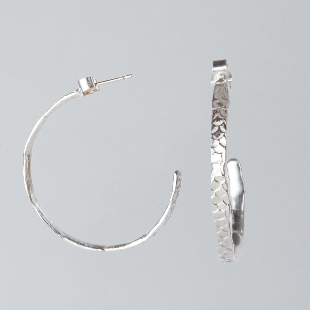 Fingerprints and scale imprints make these hoops so magical and unique. Hand crafted by Josie Mitchell Jewellery using the lost wax casting technique, the hoops feature traces of the human touch and an organic, earthy texture with Josie's signature Siren details.