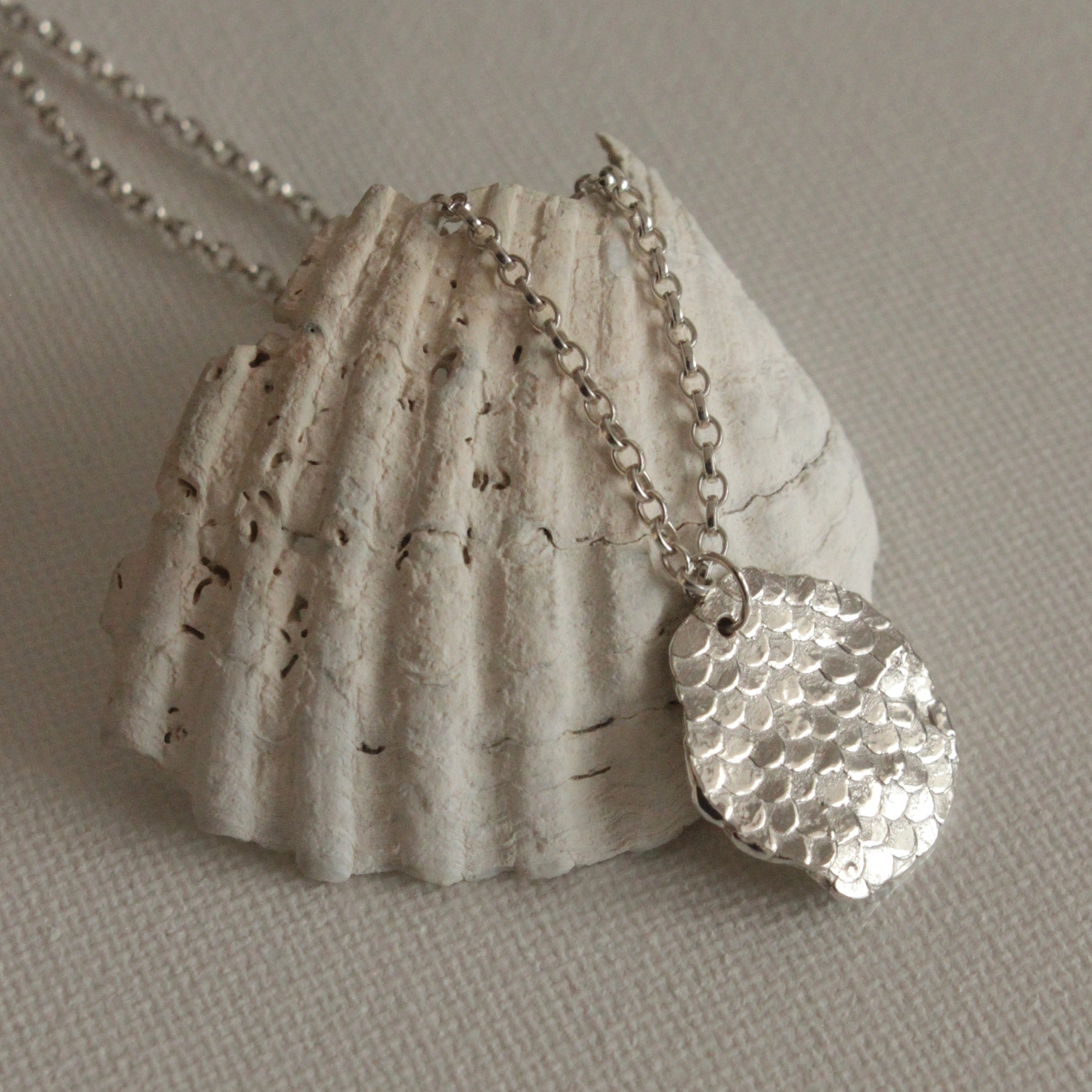The Inner Guidance pendant is full of organic, oceanic textures and features the signature Siren details on the front. Hold the pendant in your fingers through times of stress to bring you a sense of ease and grounding. Enjoy the weight of the pendant and layer with other necklaces to create your very own style.