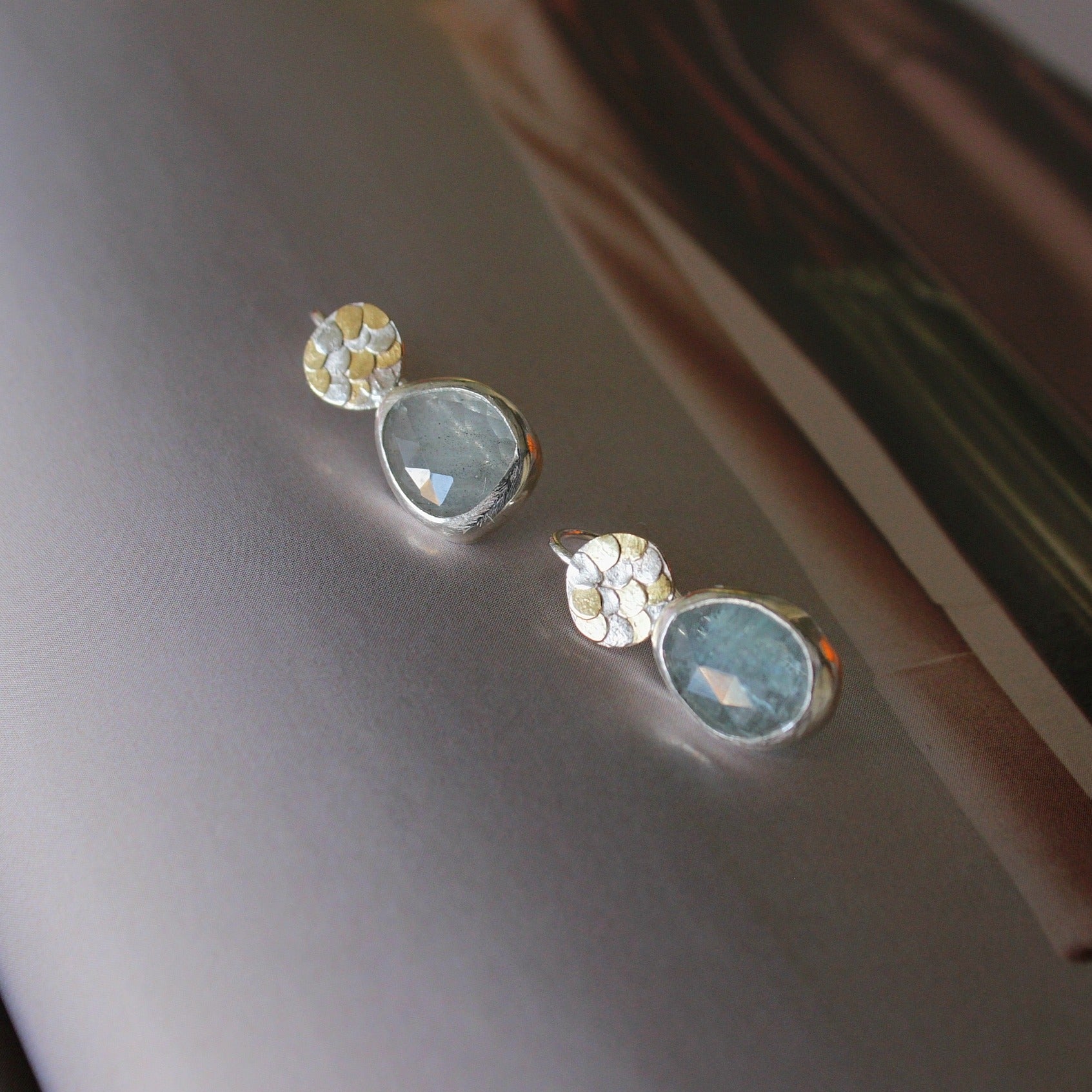 The handcrafted Aquamarine Siren drop earrings by Josie Mitchell Jewellery are one-of-a-kind and completely unique. The vibrant Aquamarines are full of magic and remind us of crystal clear Mediterranean waters. The earrings include Josie's signature Siren scale detailing at the top for the most magical pair of earrings..